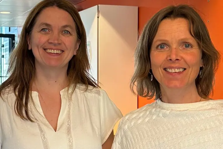 A couple of women smiling