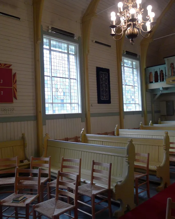 A dining room with a chandelier and chairs