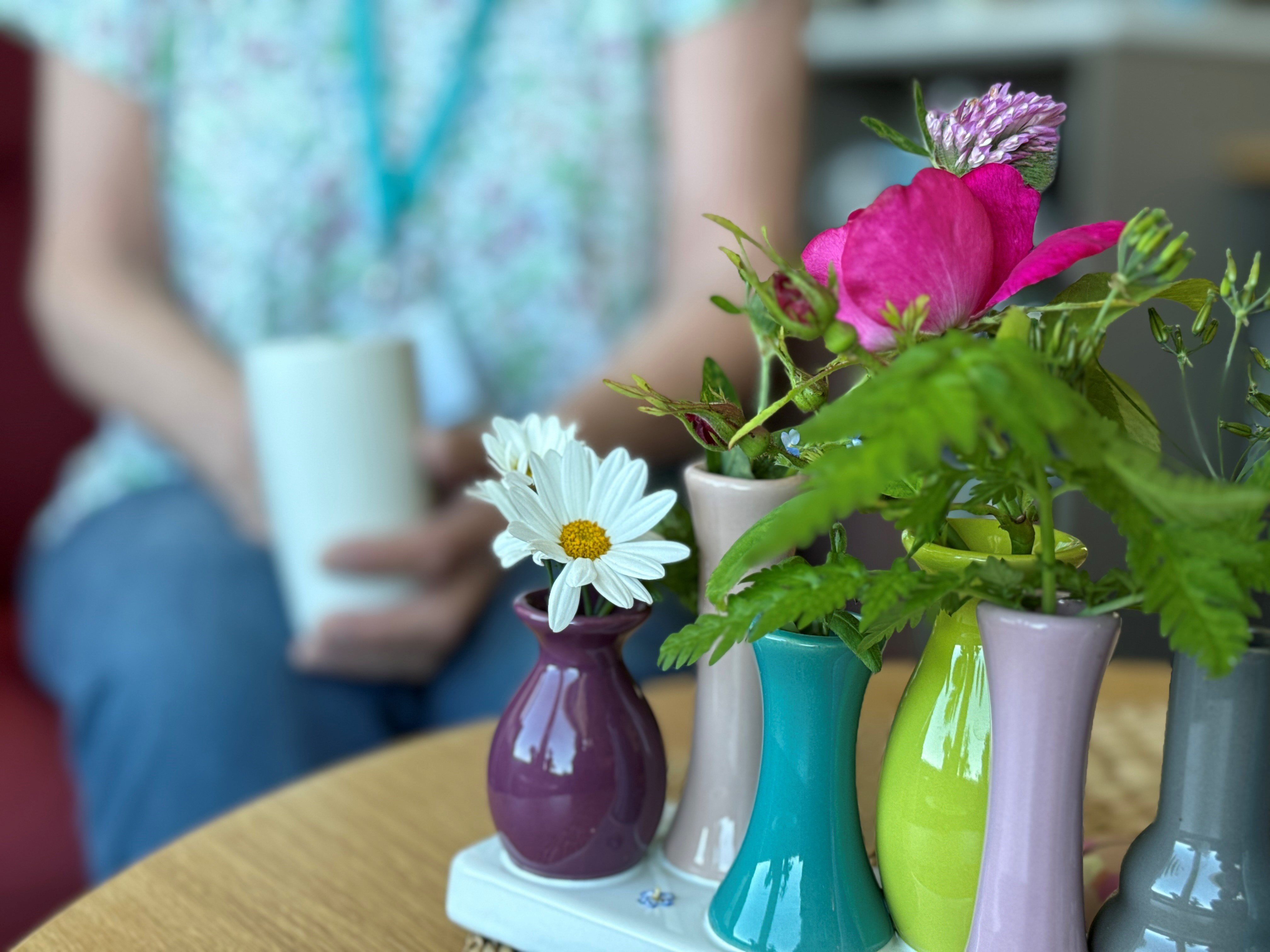 En gruppe blomster sitter i en vase