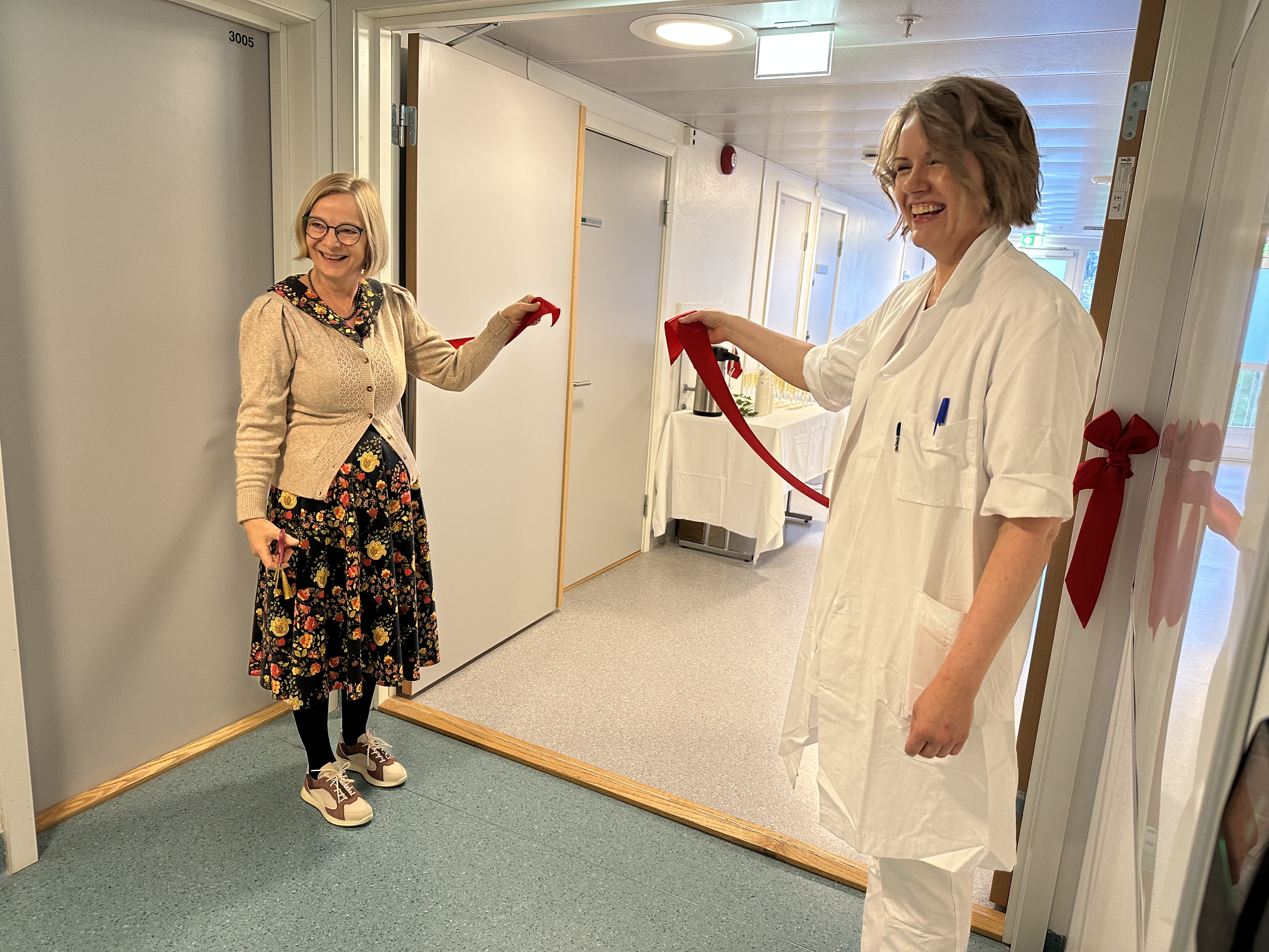 To damer som holder en rød snor