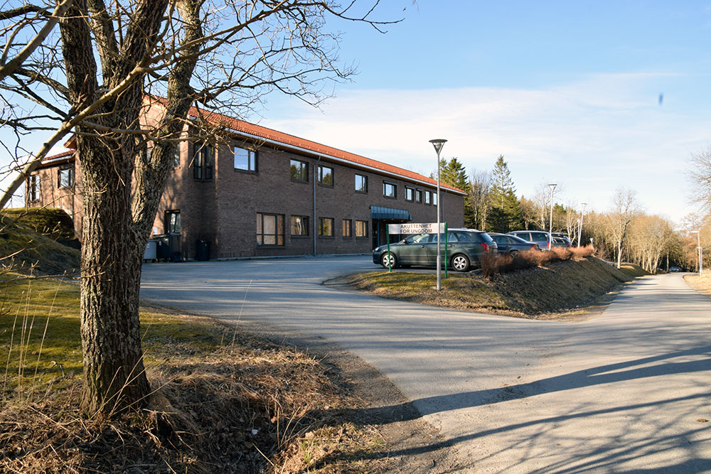 En bygning med biler parkert foran