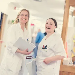 A few women in white lab coats
