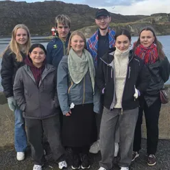 A group of people posing for a photo outside