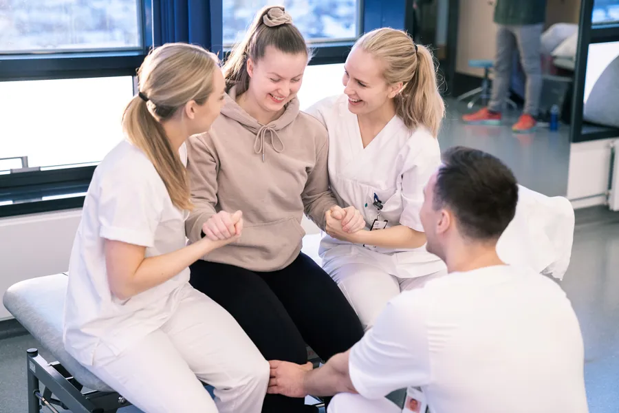 Physical therapist helping young patient